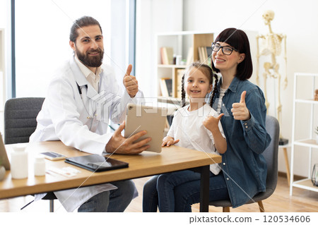Caucasian doctor shares positive test results with young girl and mother Caucasian doctor shares positive test results with young girl and mother 120534606