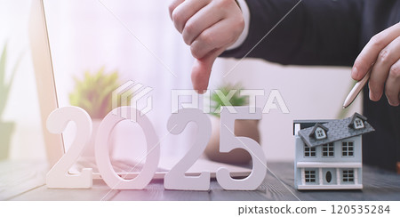 2025 Real Estate Market Challenges: Businessman Showing Disapproval with House Model and Economic Indicators 2025 Real Estate Market Challenges: Businessman Showing Disapproval with House Model and Economic Indicators 120535284