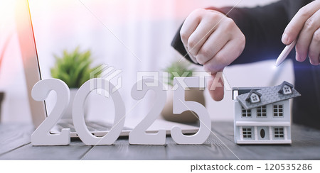 2025 Real Estate Market Challenges: Businessman Showing Disapproval with House Model and Economic Indicators 2025 Real Estate Market Challenges: Businessman Showing Disapproval with House Model and Economic Indicators 120535286