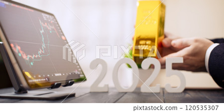 2025 Investment Trends: Businessman Holding Gold Bar with Digital Financial Charts and Market Indicators 2025 Investment Trends: Businessman Holding Gold Bar with Digital Financial Charts and Market Indicators 120535307