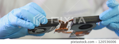 Male master in gloves holds cooling system of broken laptop 120536006