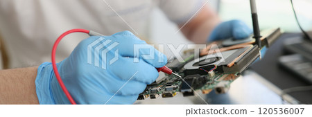 Man in gloves checkups computer motherboard at workplace 120536007
