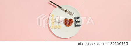A Love symbol made of heart shaped pancake, marshmallow and fruits on the white plate with fork A Love symbol made of heart shaped pancake, marshmallow and fruits on the white plate with fork 120536185