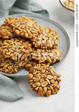 A heap of Portugues traditional peanut cookies known as Bolachas de Amendoim on the grey plate A heap of Portugues traditional peanut cookies known as Bolachas de Amendoim on the grey plate 120536195