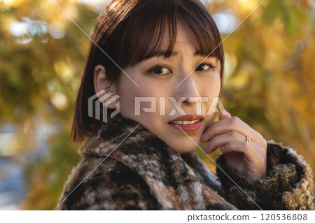 A young woman with short hair walking through the park 120536808