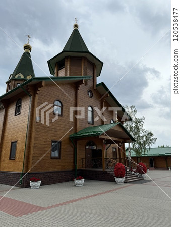 Wooden Orthodox Church with Green Roof and Golden Domes Wooden Orthodox Church with Green Roof and Golden Domes 120538477