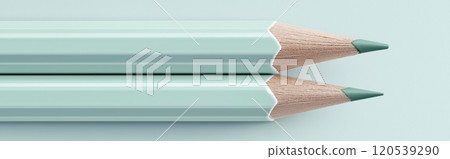 Two mint green pencils aligned horizontally with sharp tips, on a light background Two mint green pencils aligned horizontally with sharp tips, on a light background 120539290