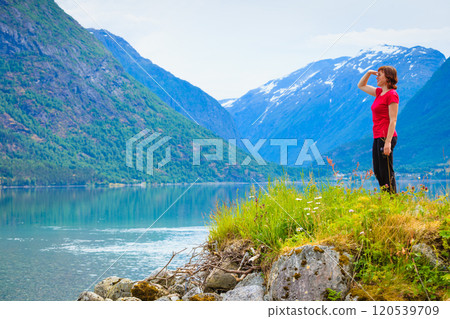 Tourist woman enjoying fjord view in Norway Tourist woman enjoying fjord view in Norway 120539709