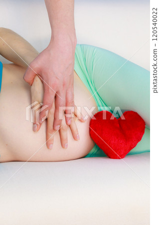 Couple expecting baby, their hands touching pregnant belly Couple expecting baby, their hands touching pregnant belly 120540022