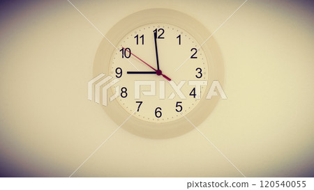clock on wall showing nine hours clock on wall showing nine hours 120540055