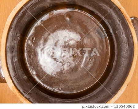 Brown clay jar view from above 120540068