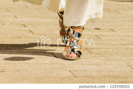 Woman wearing high heels and culottes Woman wearing high heels and culottes 120540081