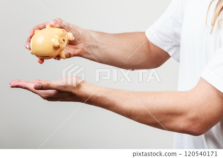 Male hands with coins and piggybank Male hands with coins and piggybank 120540171
