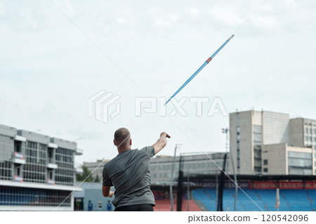 Person Throwing Javelin During Athletic Event Person Throwing Javelin During Athletic Event 120542096