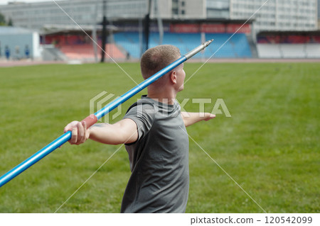 Practicing Javelin Techniques on Sports Field Practicing Javelin Techniques on Sports Field 120542099