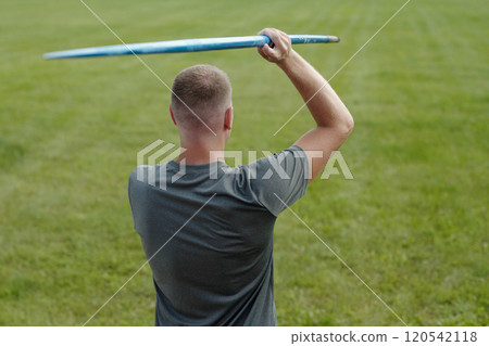 Man Throwing Frisbee Outdoor on Green Field Man Throwing Frisbee Outdoor on Green Field 120542118