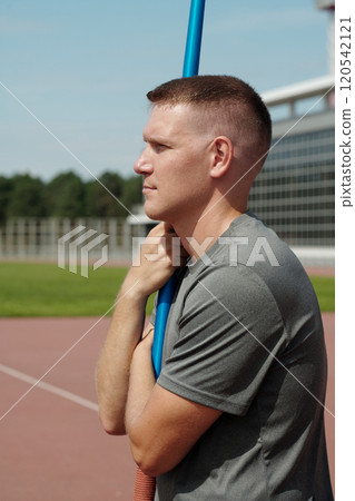 Athlete Holding Pole Vault on Outdoor Track Athlete Holding Pole Vault on Outdoor Track 120542121