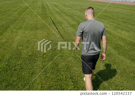 Walking Away on Running Track with Green Lawn 120542137