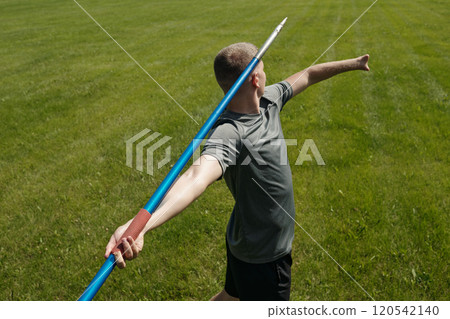 Throwing Javelin on Green Grass Field with Determination Throwing Javelin on Green Grass Field with Determination 120542140