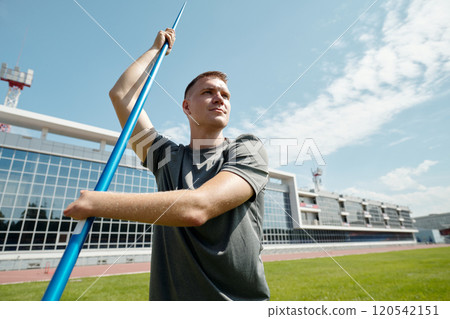 Athlete Throwing Javelin on Athletics Field 120542151