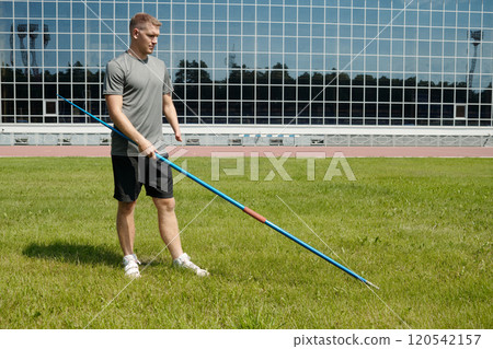 Practicing Javelin Throw on Outdoor Sports Field 120542157