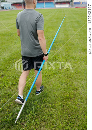 Holding Javelin While Preparing for Athletic Practice Outdoors Holding Javelin While Preparing for Athletic Practice Outdoors 120542167