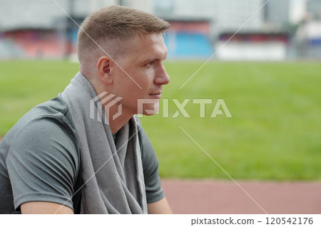 Profile of Young Athlete Sitting on Stadium Track Profile of Young Athlete Sitting on Stadium Track 120542176