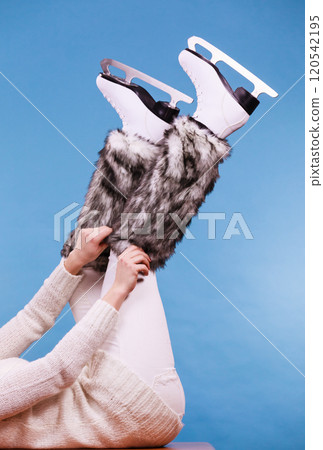 Woman legs wearing ice skates fur socks, skating 120542195