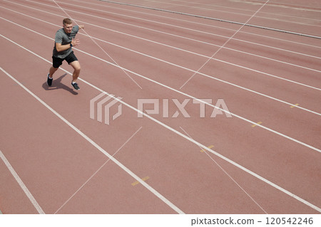 Athletic Man Running on Track During Exercise Athletic Man Running on Track During Exercise 120542246