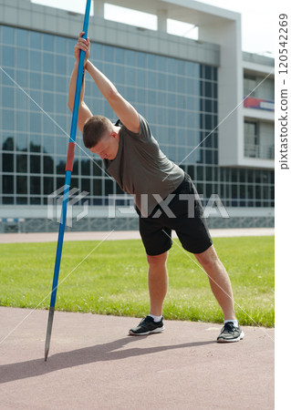 Practicing Javelin Throw Outdoors on Sunny Day Practicing Javelin Throw Outdoors on Sunny Day 120542269