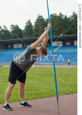 Stretching Before Pole Vaulting On Athletic Track Stretching Before Pole Vaulting On Athletic Track 120542271