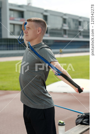 Stretching and Exercising with Resistance Band Outdoors Stretching and Exercising with Resistance Band Outdoors 120542278