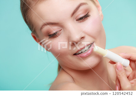 woman applying balsam for lips woman applying balsam for lips 120542452