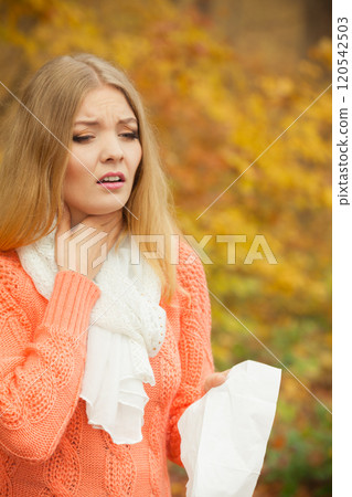 Sick ill woman in autumn park. Sick ill woman in autumn park. 120542503