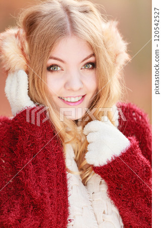 Portrait of pretty smiling woman in earmuffs. Portrait of pretty smiling woman in earmuffs. 120542527