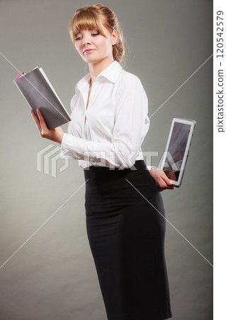 Woman learning with ebook and book. Education. 120542579