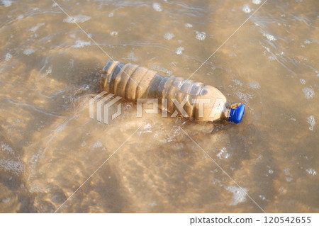 Plastic bottle on the beach, closeup of photo with soft focus Plastic bottle on the beach, closeup of photo with soft focus 120542655