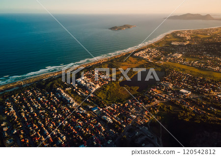 Coastline with ocean and town with sunset tones in Florianopolis 120542812