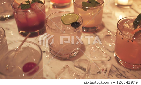 Elegant array of alcoholic beverages at a black tie event with ambient low lighting 120542979