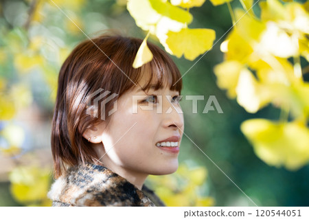 Young woman enjoying autumn leaves hunting Young woman enjoying autumn leaves hunting 120544051