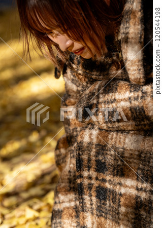 Young woman enjoying autumn leaves hunting Young woman enjoying autumn leaves hunting 120544198
