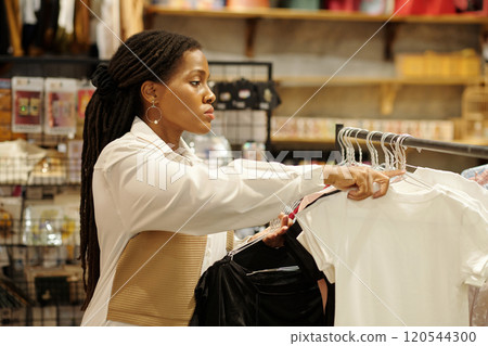 Browsing Clothes in Retail Store While Shopping 120544300