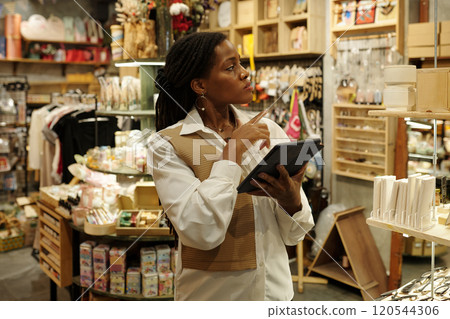 African American Woman Holding Tablet in a Store 120544306