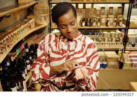 Smiling Woman Standing in Natural Health Store Smiling Woman Standing in Natural Health Store 120544327