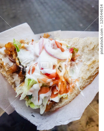 Closeup on tasty Kebab in a man's hand. 120544654