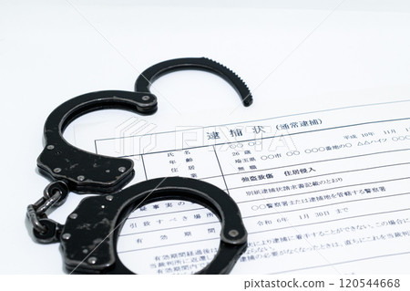 Image of a dark job: arrest warrant and black handcuffs Image of a dark job: arrest warrant and black handcuffs 120544668