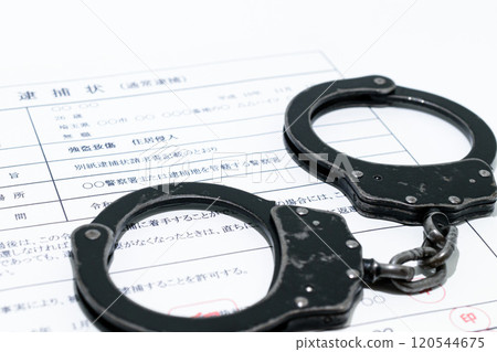 Image of a dark job: arrest warrant and black handcuffs 120544675