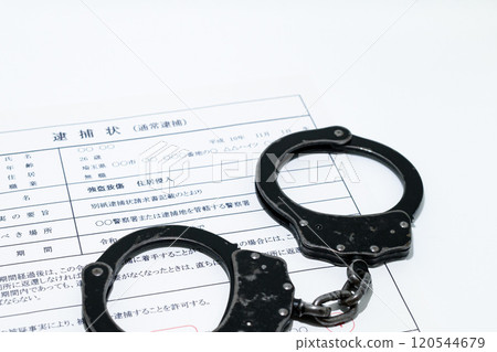 Image of a dark job: arrest warrant and black handcuffs Image of a dark job: arrest warrant and black handcuffs 120544679