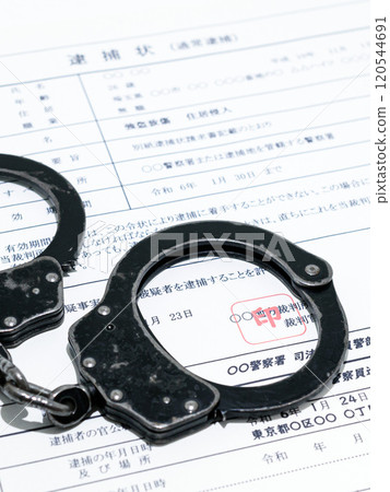 Image of a dark job: arrest warrant and black handcuffs Image of a dark job: arrest warrant and black handcuffs 120544691