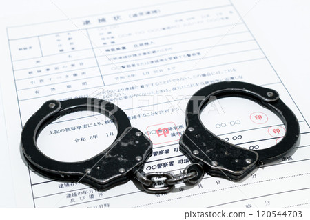 Image of a dark job: arrest warrant and black handcuffs Image of a dark job: arrest warrant and black handcuffs 120544703